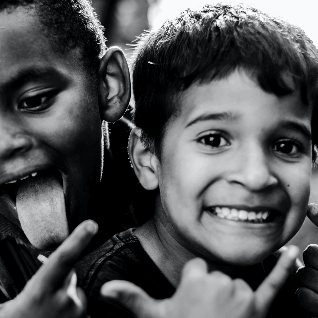 Two young boys celebrating as EPIC helps change the narrative around poverty.