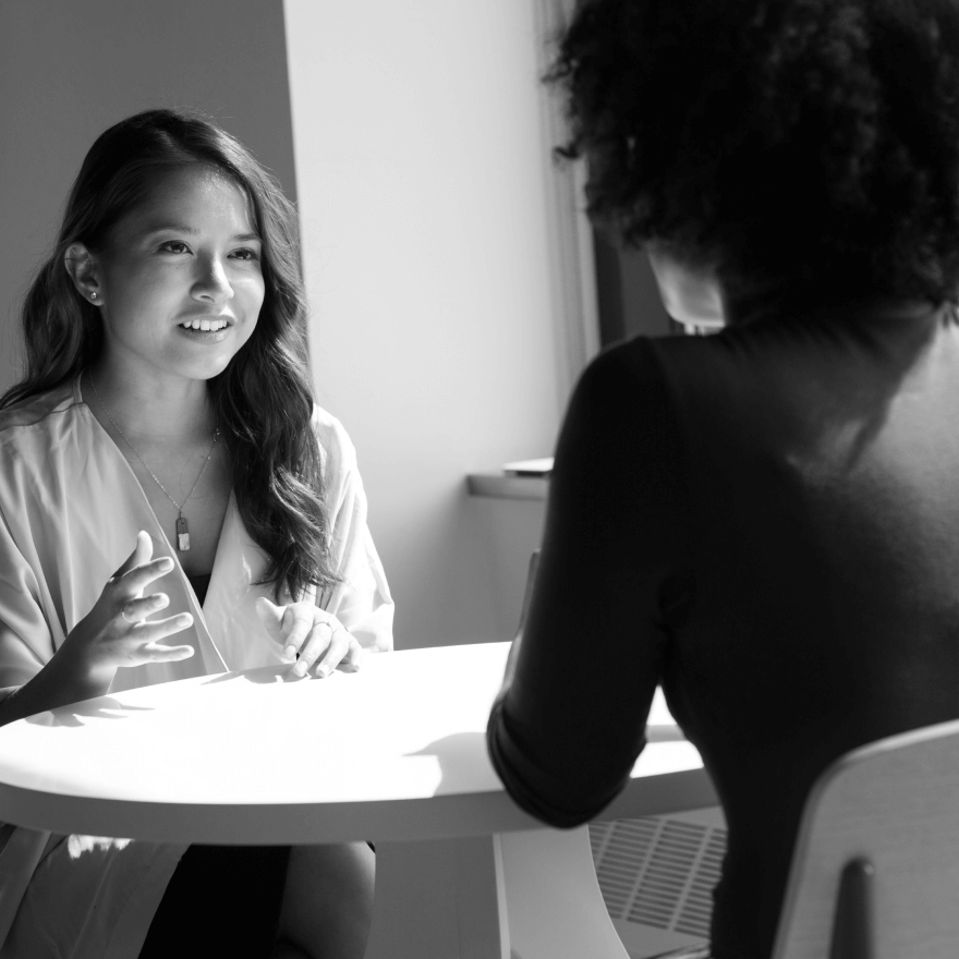 Two women having a conversation at a table